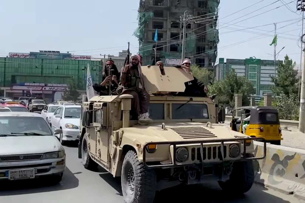 Taliban fighters riding the top of a US-supplied HUMVEE in 2021 - the real result of USAID's "local governance training." 