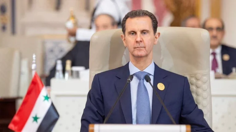 A photo of Bashar Al-Assad at a podium