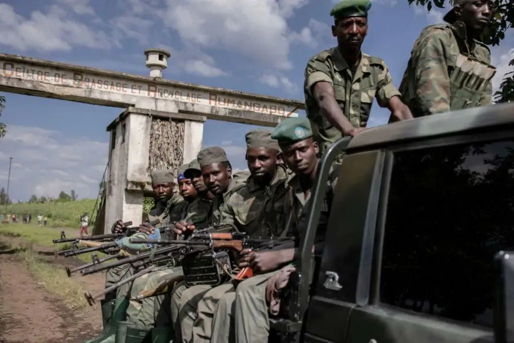 A picture of Congolese soldiers sitting in the bed of a technical 