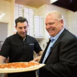 A photo of Doug Ford admiring a pizza indicating How Not to Negotiate: Doug Ford’s Masterclass in Folding Like a Cheap Suit