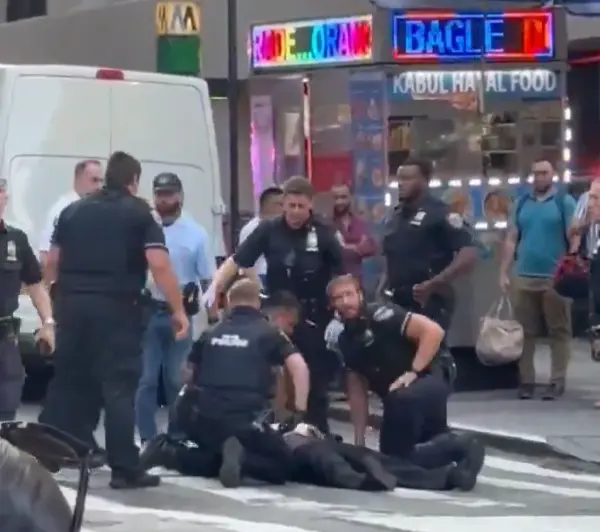 NYPD officer receiving CPR after being shot my gunman in New York City July 28 attack 