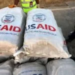 a depiction of USAID aid bags illustrating USAID's Track Record A History of Humanitarian Failures