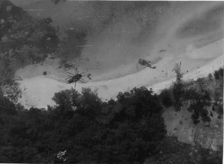 The wreckage of U.S. Air Force CH-53 helicopters Knife 23 (left) and Knife 31 (right), shot down during the battle, lying on Koh Tang's East Beach shortly after the battle By UISAF - https://www.phnompenhpost.com/post-weekend/hell-revisited, Public Domain, https://commons.wikimedia.org/w/index.php?curid=73649186