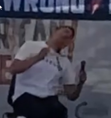 a screenshot of a video of Charlie Kirk's assassination suggesting the bullet took a downwards trajectory. 
