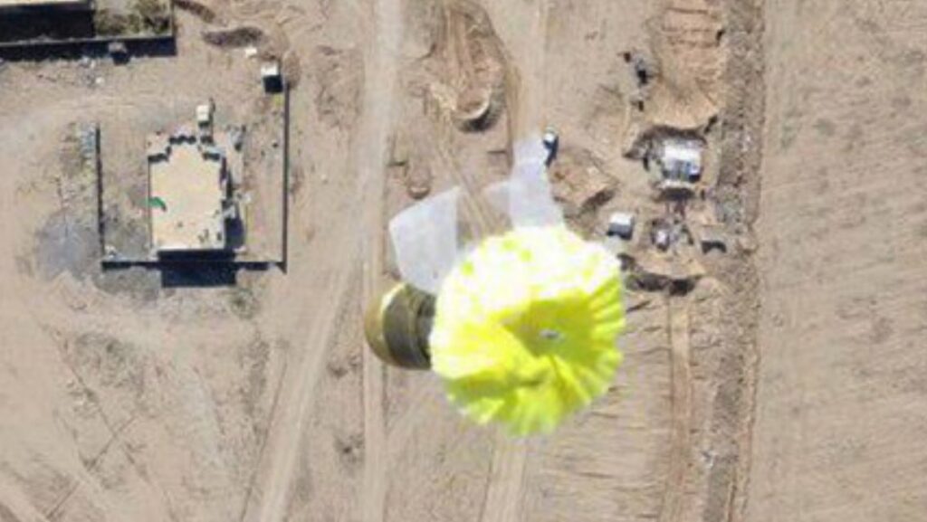 an FPV image of a terrorist drone dropping a parachute grenade in Syria
